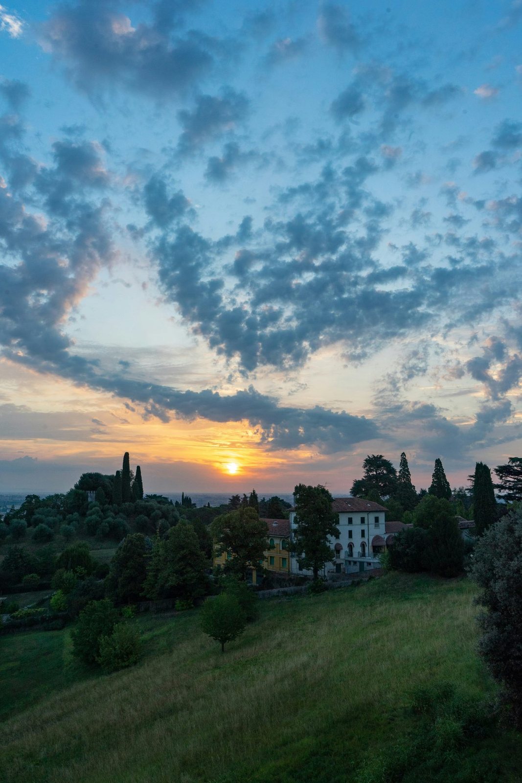 Sunset over the hills and houses of Marano Vicentino
